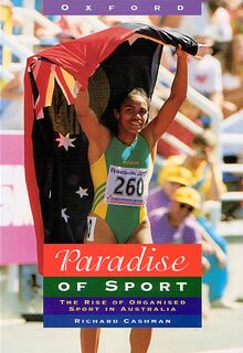 Paradise of Sport cover photo showing cathy freeman after race with flags